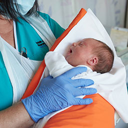 Midwife holiding a newborn baby